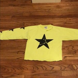 Neon yellow crewneck with stars and rip at neck